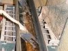 This contraption prepares the ukulele sides for bending. You can see pieces of straight wood in the hot water. The forklike contraptions are used to pick up the pieces of koa.